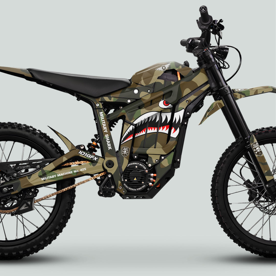Talaria Sting MX5 PRO Graphics Kit MILITARY SHARK Camo Decals on an off-road electric bike, featuring shark-mouth graphics, high-clearance suspension, and knobby tires for rugged terrain.