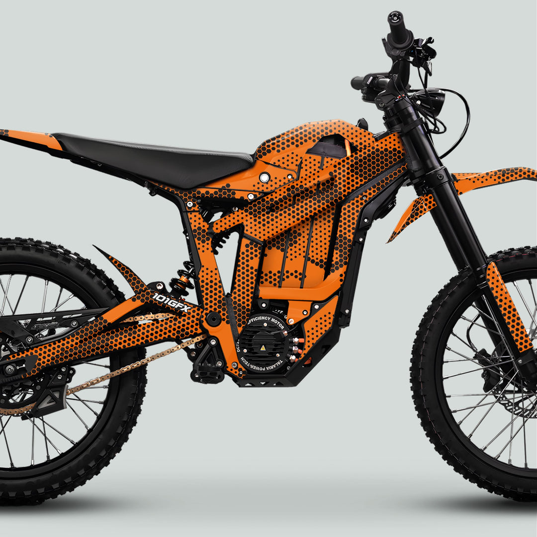 Talaria Sting MX5 PRO Graphics Kit HEXOCAM ORANGE Decals on an off-road electric dirt bike's right-side profile, showcasing the sleek honeycomb-patterned frame and chunky tires.