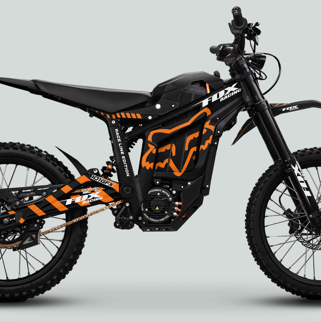 Talaria Sting MX5 PRO Graphics Kit FOX RACELINE, featuring a black electric dirt bike with orange decals, knobby tires, front forks, and integrated battery housing.