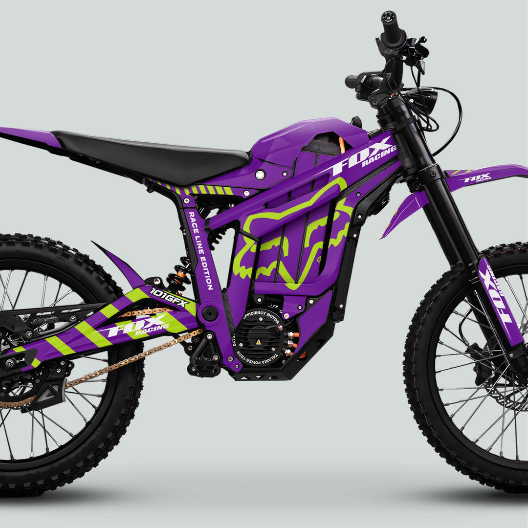 Talaria Sting MX5 PRO Graphics Kit FOX RACELINE Purple Green Decals on electric dirt bike, showcasing off-road features like knobby tires, suspension, and branding.