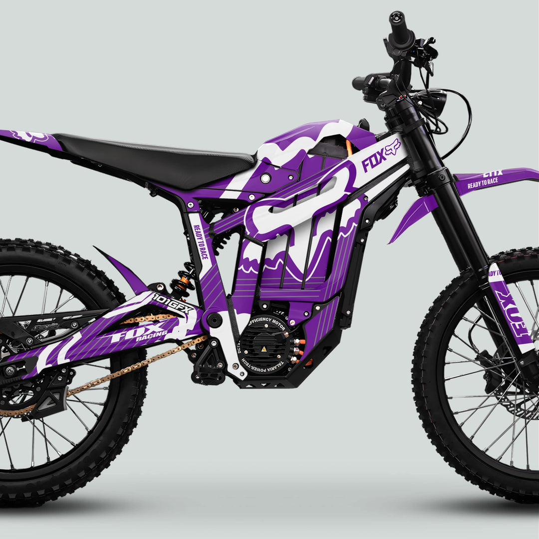 Talaria Sting MX5 PRO Graphics Kit featuring Fox Racing livery with knobby tires, long-travel suspension, mid-frame battery, showcasing the FOX STRIPES Purple White Decals.