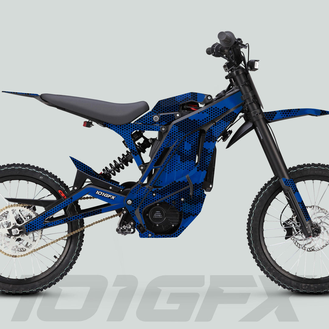 Side view of an electric dirt bike featuring the E Ride Pro SS Graphics Kit HEXOCAM BLUE, showcasing chunky tires, long-travel forks, and sleek blue/black graphic wrap.