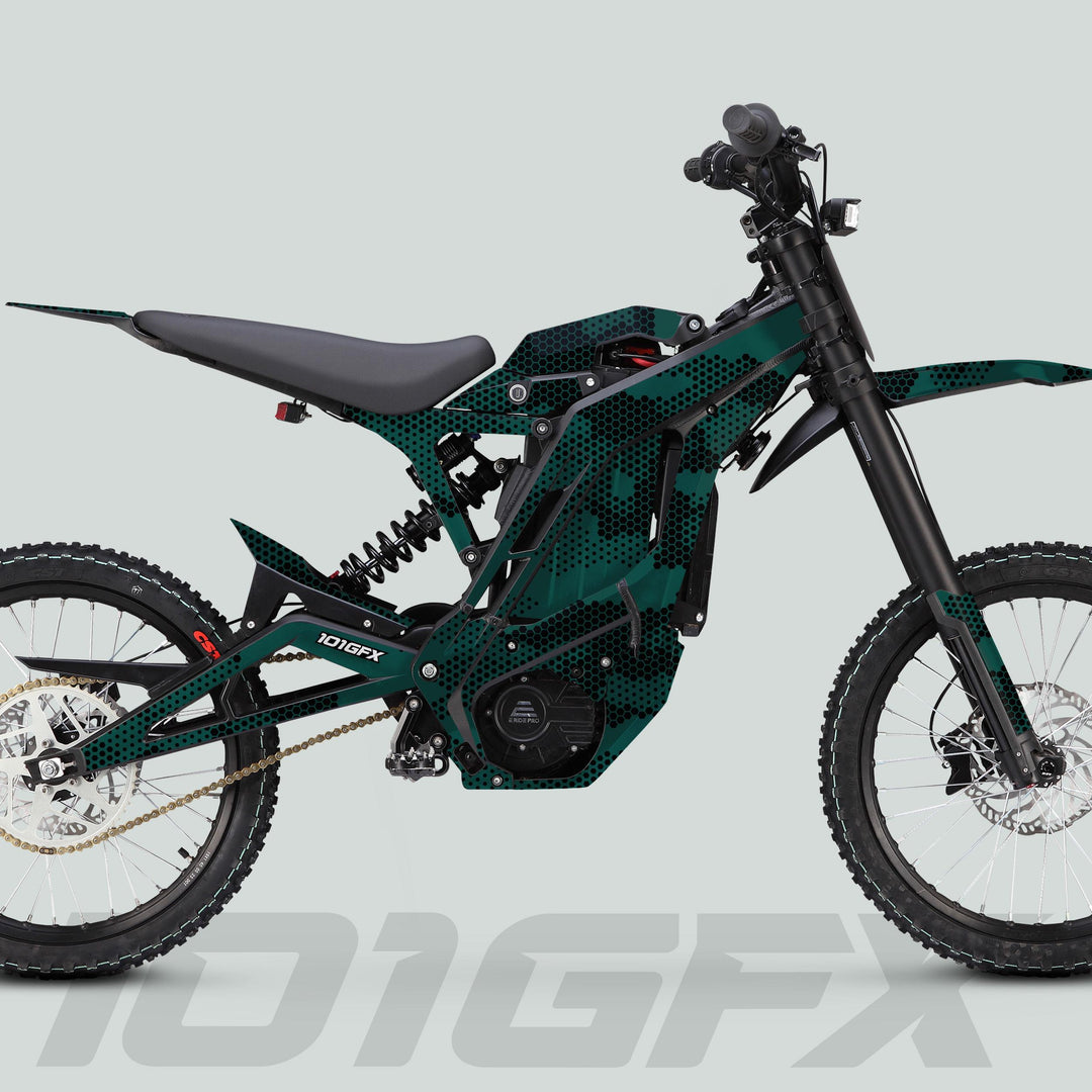 Side-view of E Ride Pro SS Graphics Kit HEXOCAM AVENTUR on electric dirt-bike, featuring camo-dot finish, knobby tires, and “101GFX” branding on swingarm.
