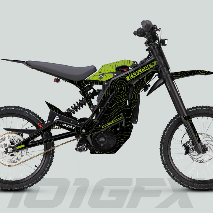 Side-profile of an off-road electric dirt bike featuring the E Ride Pro SS Graphics Kit EXPLORER Black Green with knobby wheels, suspension, and sleek decals.