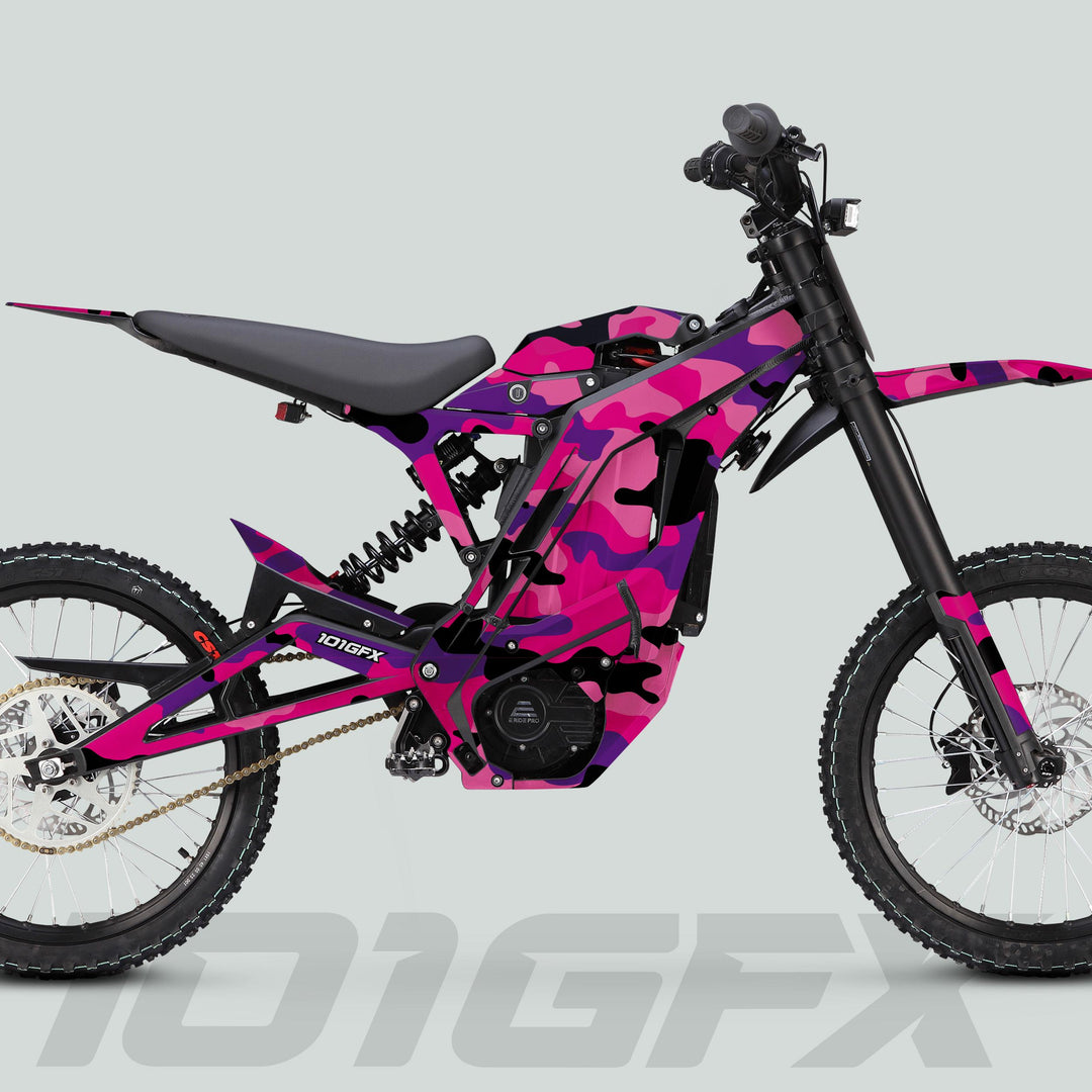 E Ride Pro SS Graphics Kit CAMOUFLAGE PINKY on off-road e-bike, showcasing pink camouflage body panels, full suspension, knobby tires, and visible model marking “101GFX.”