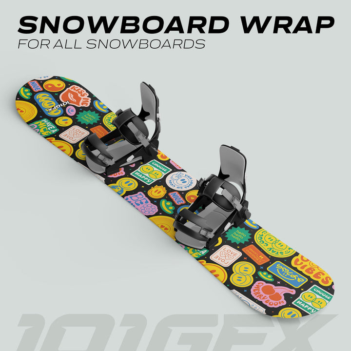 Snowboard with black bindings, featuring GOOD VIBES sticker skin covered in colorful emoji icons and slogans, designed for style and board protection.