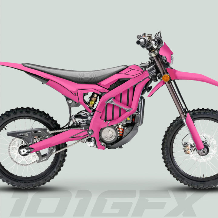 Surron Ultra Bee Graphics Kit SOLID COLOR PINK on a dirt motorcycle, showcasing knobby tires, suspension, and sleek design, enhancing aesthetics and protection.