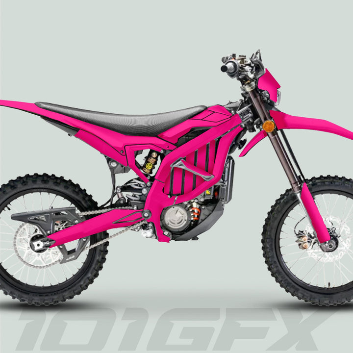 Side-view of a pink off-road motorcycle featuring the Surron Ultra Bee Graphics Kit SOLID COLOR MAGENTA with knobby tires and electric motor for enhanced style and protection.