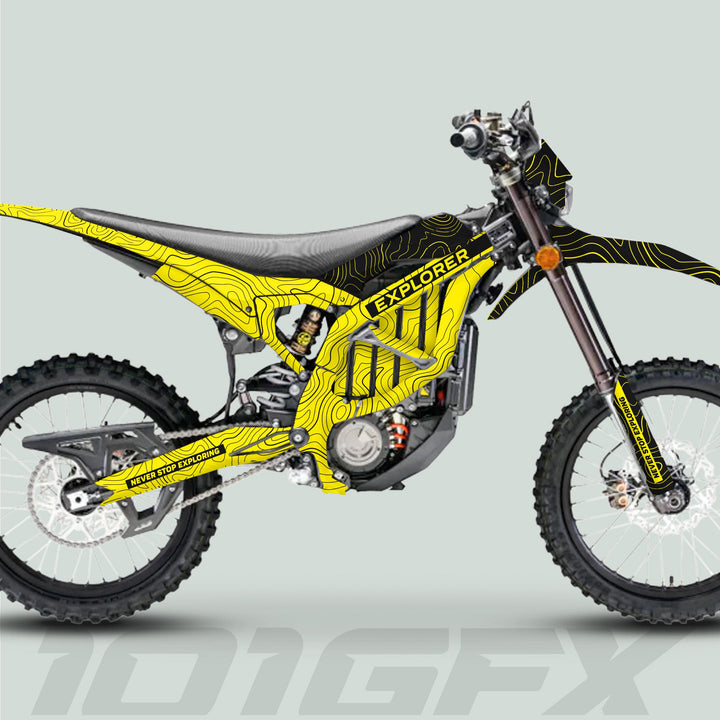 Surron Ultra Bee Graphics Kit EXPLORER YELLOW BLACK on dirt bike, featuring contour-map lines, “EXPLORER” text, knobby tires, and exposed engine.