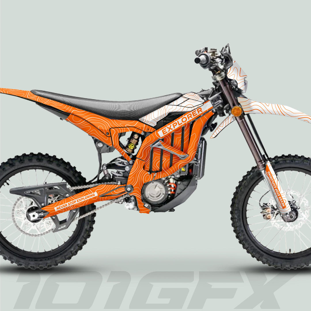 Surron Ultra Bee Graphics Kit EXPLORER ORANGE WHITE on a dirt bike, featuring bold topographic design and NEVER STOP EXPLORING accents for standout style and protection.