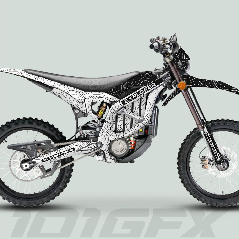 Surron Ultra Bee Graphics Kit EXPLORER WHITE BLACK on a dirt motorcycle, showcasing a topographic map design with “NEVER STOP EXPLORING” tagline, enhancing aesthetics and protection.