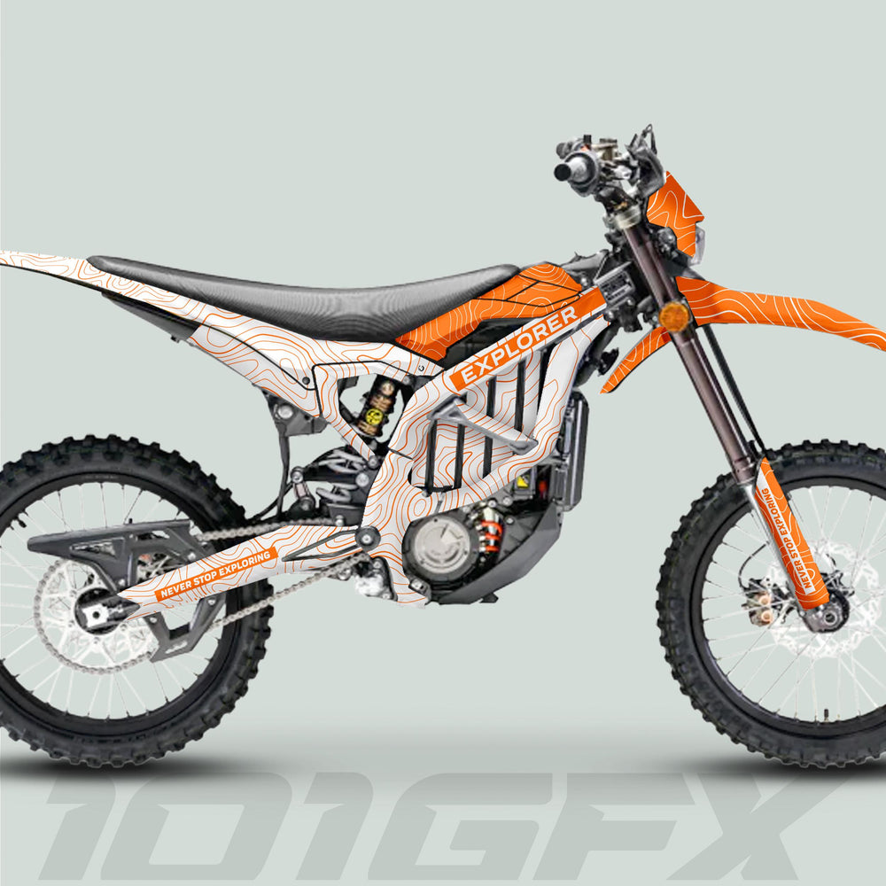 Surron Ultra Bee Graphics Kit EXPLORER WHITE ORANGE on an off-road motorcycle with contour-line patterns, knobbly tires, and NEVER STOP EXPLORING slogan.