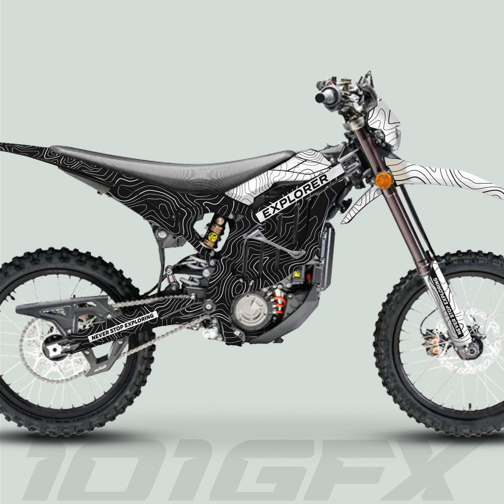 Surron Ultra Bee Graphics Kit EXPLORER BLACK WHITE on dirt bike, featuring topographic-line graphics, EXPLORER text, and knobby tires for off-road adventure.