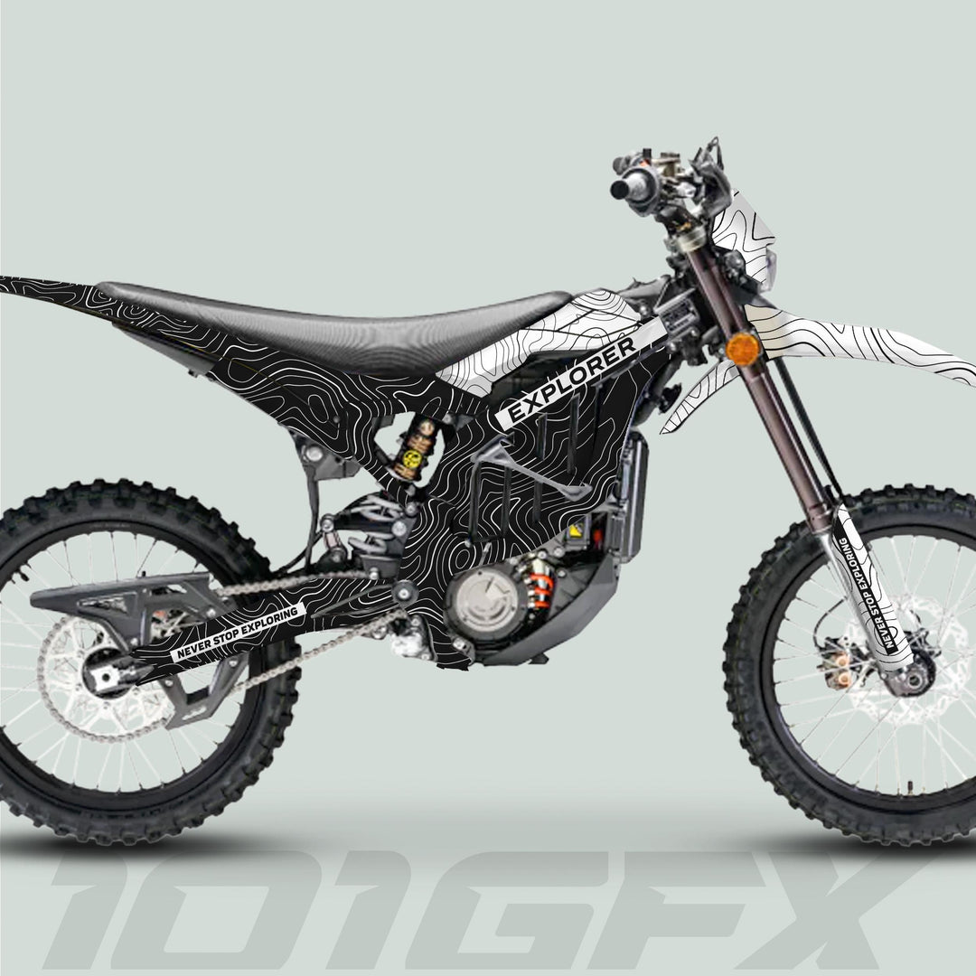 Surron Ultra Bee Graphics Kit EXPLORER BLACK WHITE on dirt bike, featuring topographic-line graphics, EXPLORER text, and knobby tires for off-road adventure.