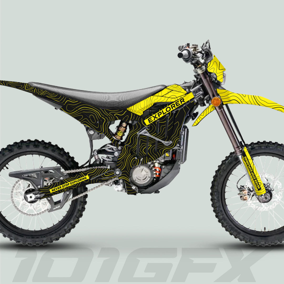 Surron Ultra Bee Graphics Kit EXPLORER BLACK YELLOW on a dirt bike, featuring topographic lines, “EXPLORER” text, knobby tires, and enduro-style design for trail use.