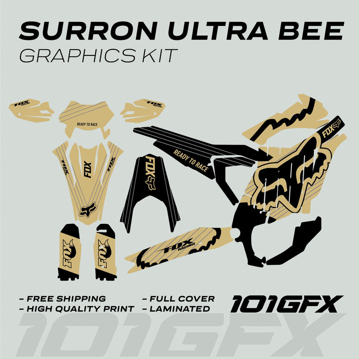 Surron Ultra Bee Graphics Kit FOX STRIPES Sand Black decals laid flat, showcasing gold-black Fox Racing design; includes fork guards, number plate, and side panels.