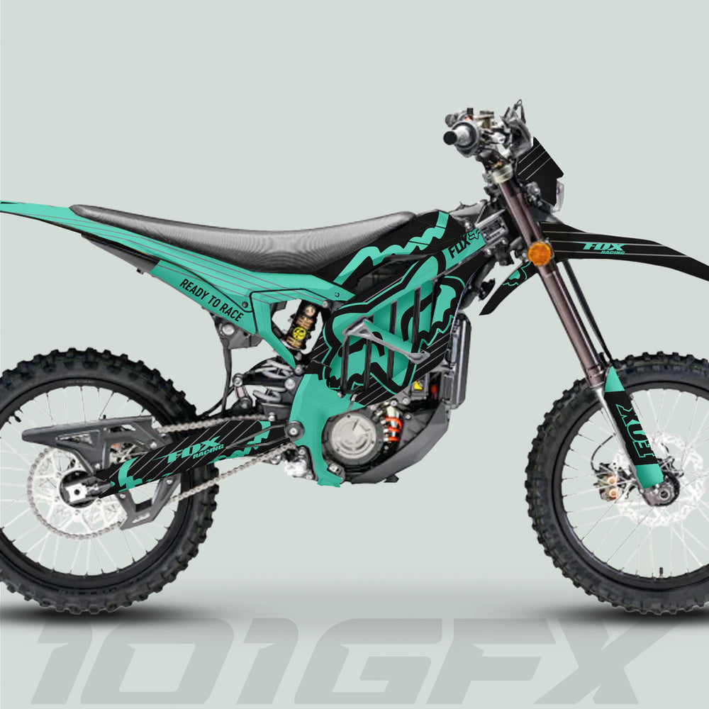 Surron Ultra Bee Graphics Kit FOX STRIPES Black Mint on motocross bike with teal-black livery, FOX branding, knobby tires, and Ready to Race decal.