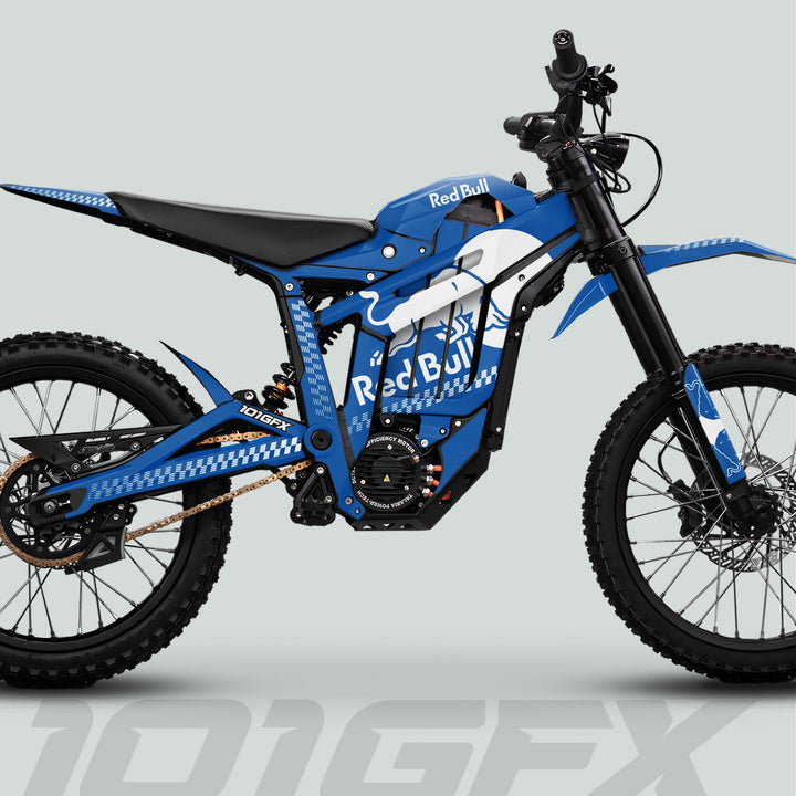 Side-profile of an e-dirt bike featuring the Talaria Sting MX5 PRO Graphics Kit RBULL MONO Blue White Decals, showcasing Red Bull branding and robust off-road components.
