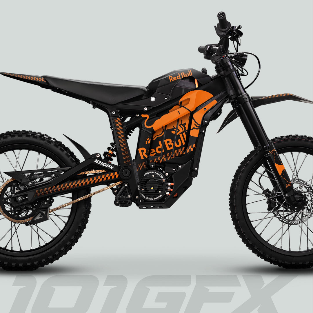 Talaria Sting MX5 PRO Graphics Kit RBULL MONO Black Orange Decals on a Red Bull–themed electric off-road motorcycle, showcasing vibrant design and knobby tires.