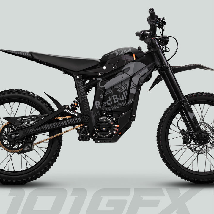 Talaria Sting MX5 PRO Graphics Kit RBULL MONO Black Grey Decals on an off-road e-bike with knobby tires, matte-black panels, and Red Bull branding.