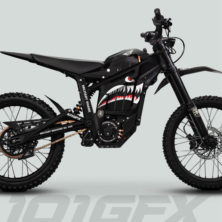 Side-profile of Talaria Sting MX5 PRO with MILITARY SHARK black decals, showcasing knobby tires, tactical design, and distinctive shark-mouth paint on battery cover.