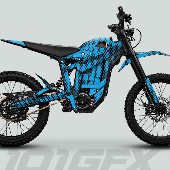 Side-profile render of Talaria Sting MX5 PRO featuring HEXOCAM CYAN Decals, highlighting the unique blue-and-black honeycomb livery on an electric dirt bike.