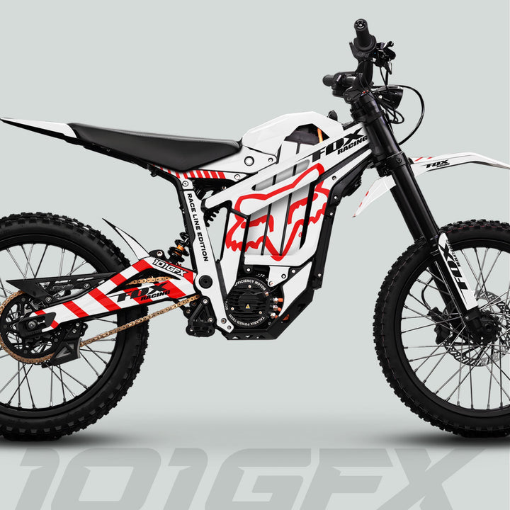 Side profile of Talaria Sting MX5 PRO with FOX RACELINE white red decals, highlighting integrated battery, knobby tires, electric motor, and dynamic Fox Racing graphics.