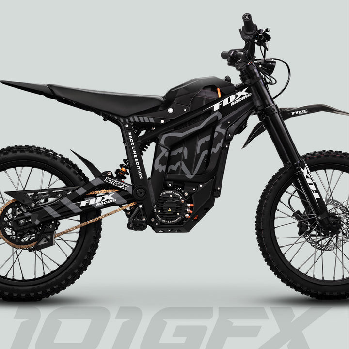 Side profile of a black Fox Racing electric off-road motorcycle, featuring knobby tires, suspension forks, and FOX RACELINE graphics kit for the Talaria Sting MX5 PRO.