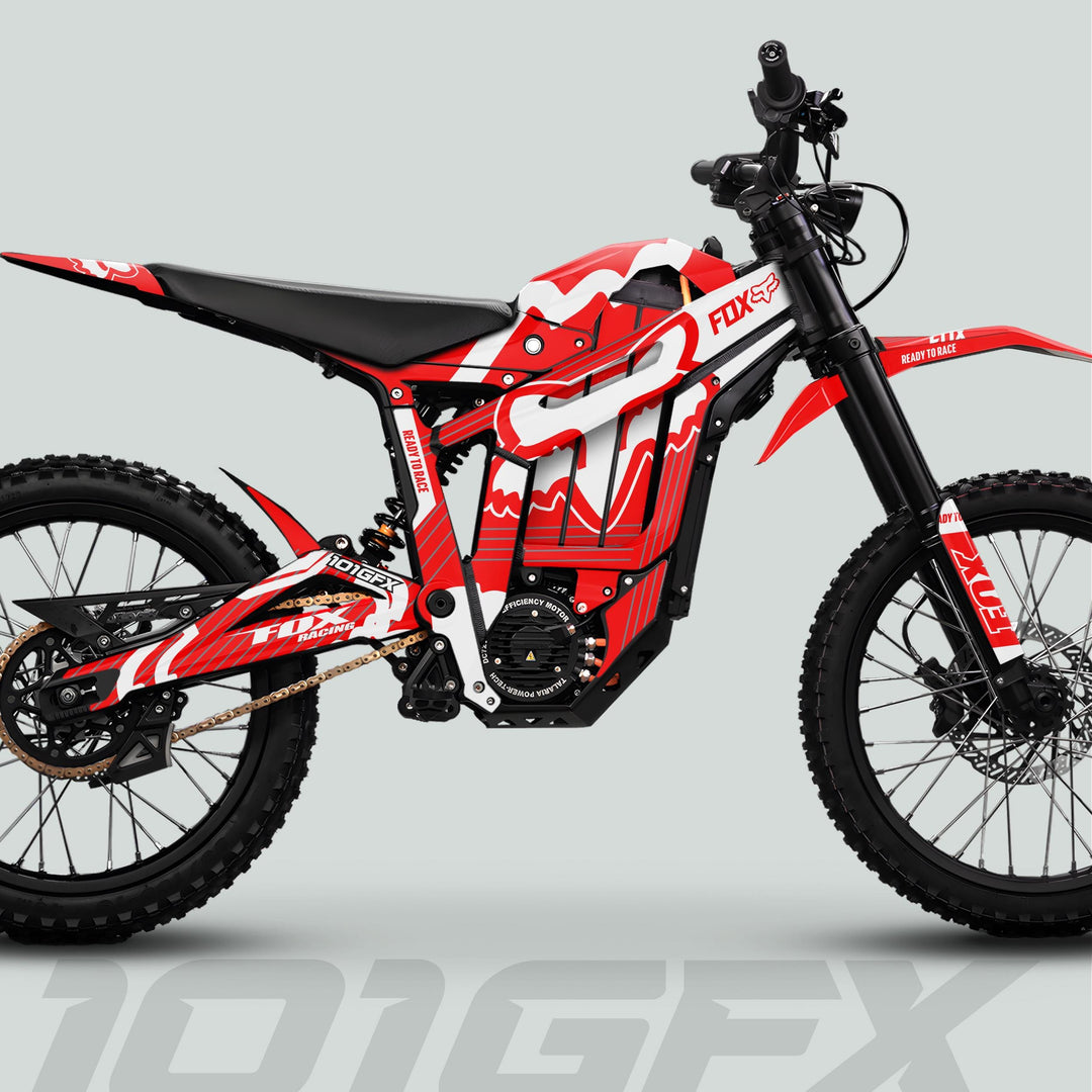Talaria Sting MX5 PRO Graphics Kit FOX STRIPES adorns a red, white, black electric dirt bike with Fox Racing logos, adding style and adventure-ready appeal.