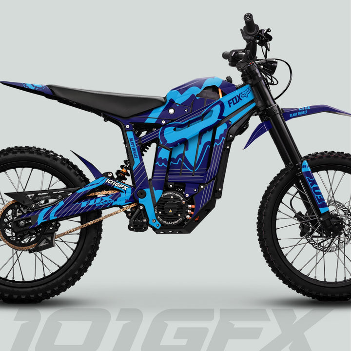 Talaria Sting MX5 PRO Graphics Kit FOX STRIPES Navy Cyan Decals on an electric off-road motorcycle with knobby tires and FOX branding.