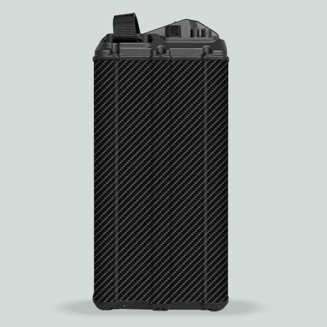 Surron Light Bee X Battery Stickers CARBON on a battery module with carbon-fiber-style shell, showing plastic top with buckle and electrical contacts.