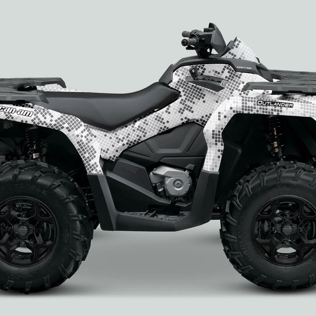 Can-Am OUTLANDER Graphics Kit in Digital Camo Winter on an ATV, showcasing pixel-camo design and knobby tires, enhancing style and protection for adventure rides.