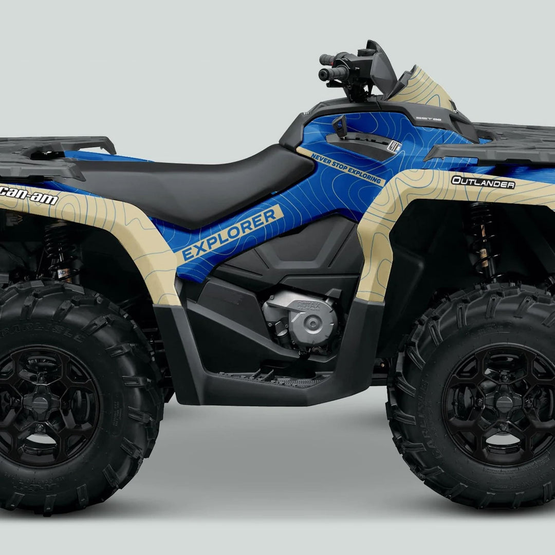 Can-Am OUTLANDER Graphics Kit EXPLORER Blue Sand on ATV, featuring blue-tan topographic design, large knobby tires, and Rotax engine for enhanced style and protection.
