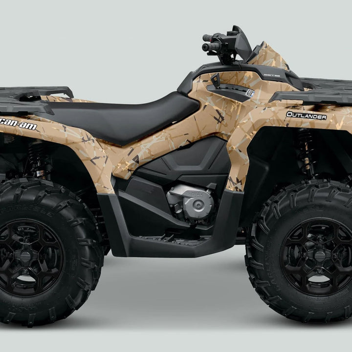 Side-profile of a Can-Am Outlander ATV with a tan-and-brown desert camo wrap, showcasing the Can-Am OUTLANDER G2 Graphics Kit SCRATCHY SAND.