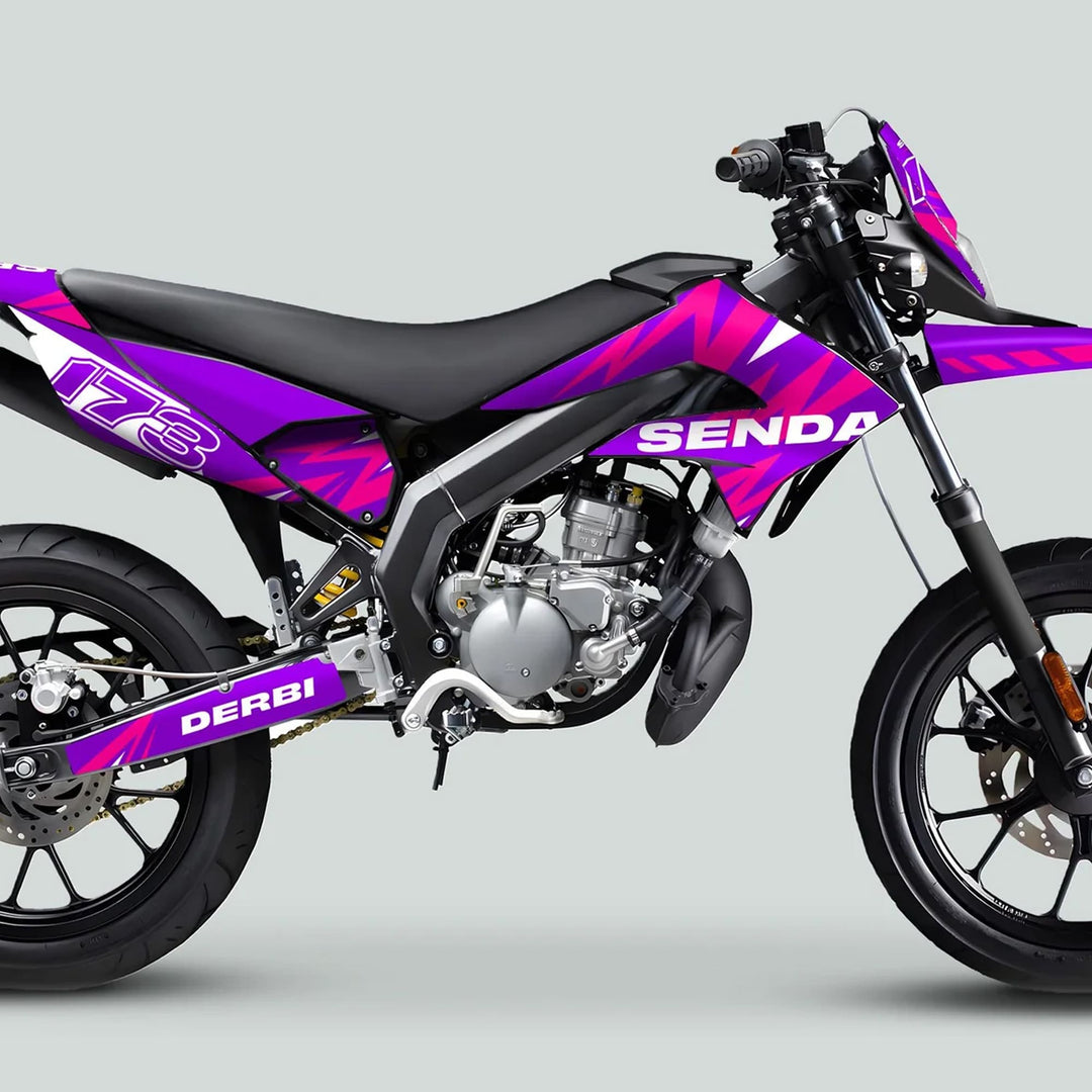Derbi Senda supermoto with Graphics Kit X-Treme 2011-2017, featuring exposed engine, black frame, and sporty wheels, showcasing the purple and pink livery design.