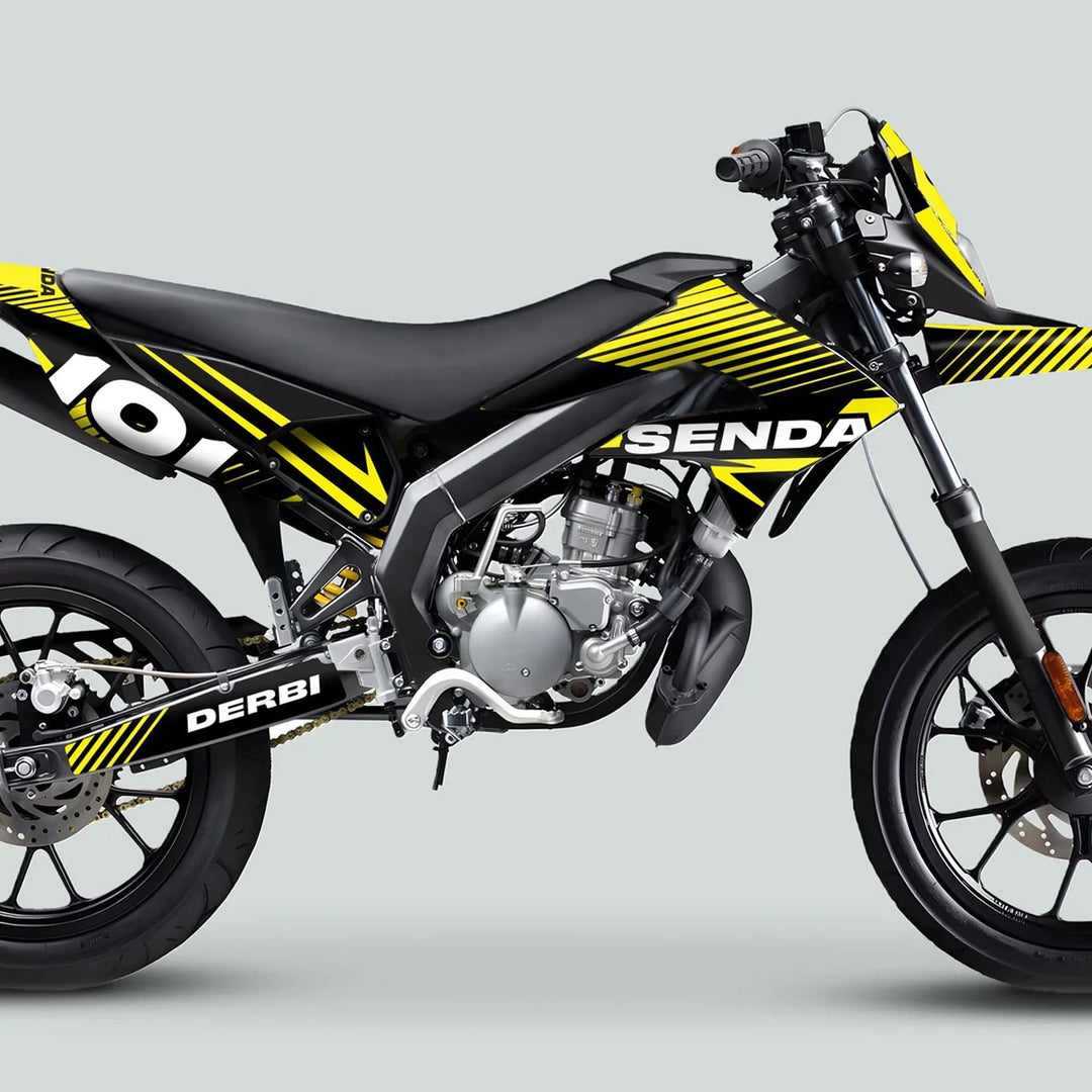 Derbi Senda Graphics Kit X-Treme 2011-2017 on a supermoto motorcycle, featuring bold black-and-yellow graphics, enhancing style and surface protection.