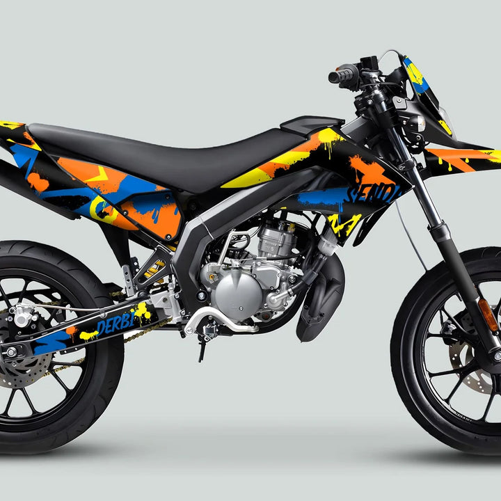 Derbi Senda Graphics Kit X-Treme 2011-2017 Splash Blue Orange on motorcycle, featuring graffiti-inspired design with spoked wheels, disc brakes, and exposed engine.