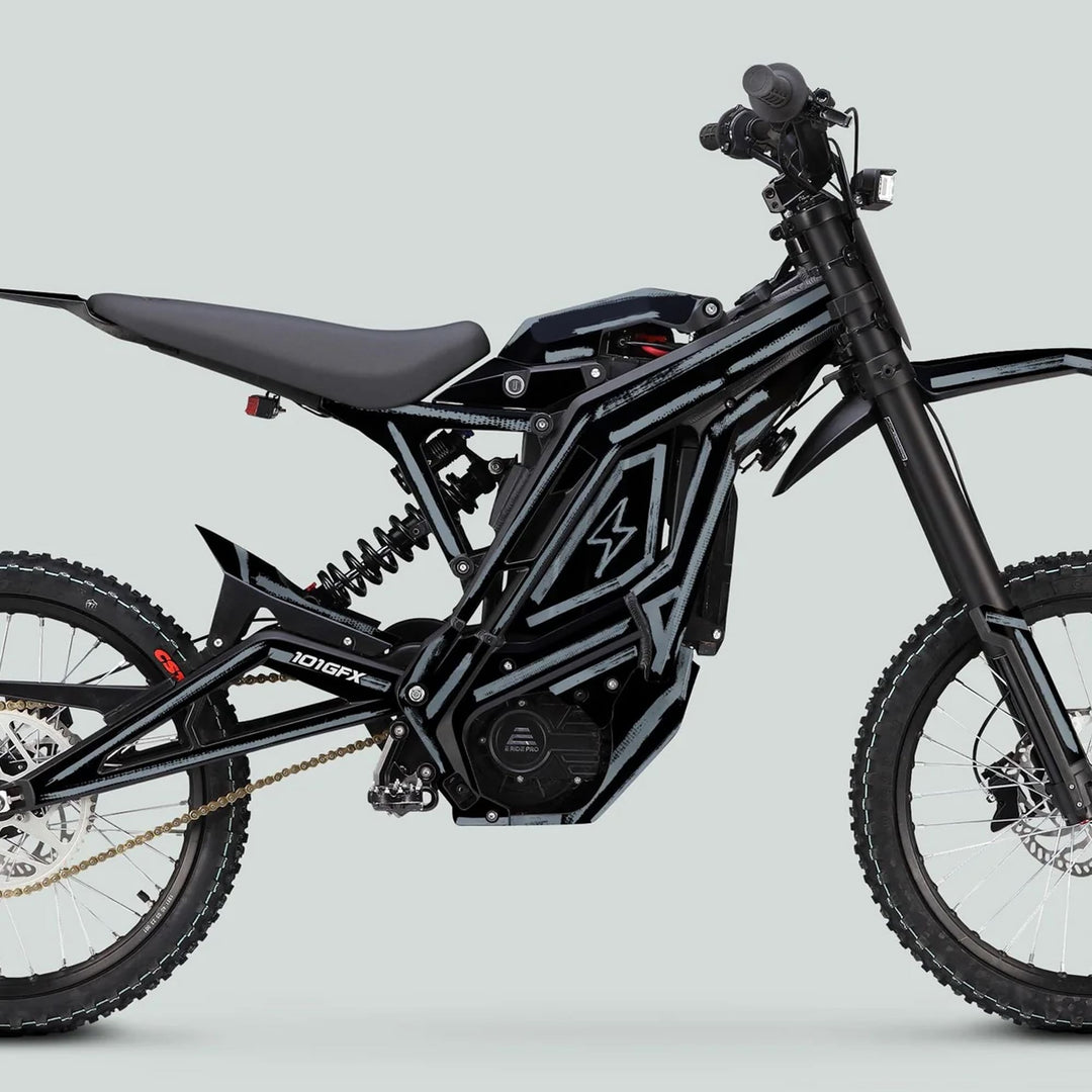 Side view of a black electric dirt-bike featuring E Ride Pro SS Graphics Kit BRUSH Black Grey, showcasing rugged tires, integrated motor, and sleek seat for off-road use.