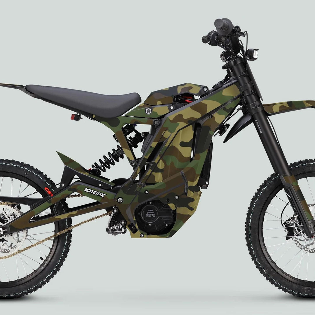 Side-profile of an E Ride Pro SS Graphics Kit CAMOUFLAGE WOODLAND on a full-suspension electric dirt bike with coil-spring suspension and knobby off-road tires.