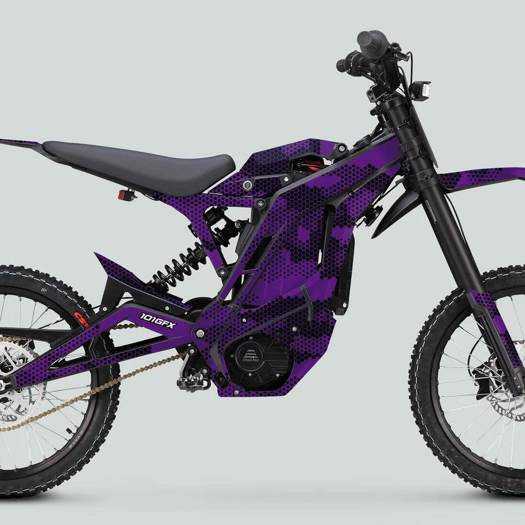 Side view of an electric off-road motorcycle adorned with the E Ride Pro SS Graphics Kit HEXOCAM PURPLE, featuring a sleek purple-and-black camo design.