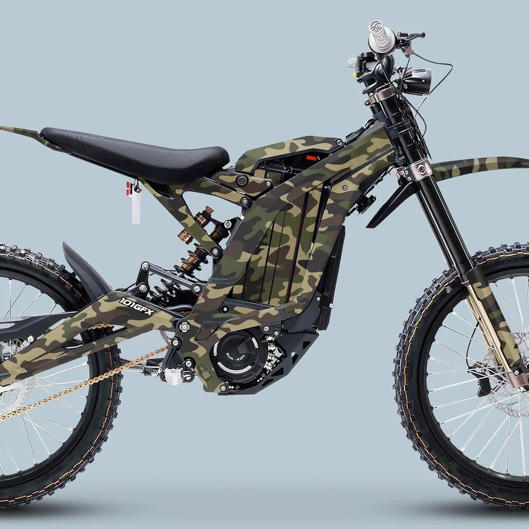 Surron Light Bee X Graphics Kit Camouflage Original Camo on an electric dirt bike, showcasing knobbly tires, central battery housing, and distinctive camo design for trail riding.