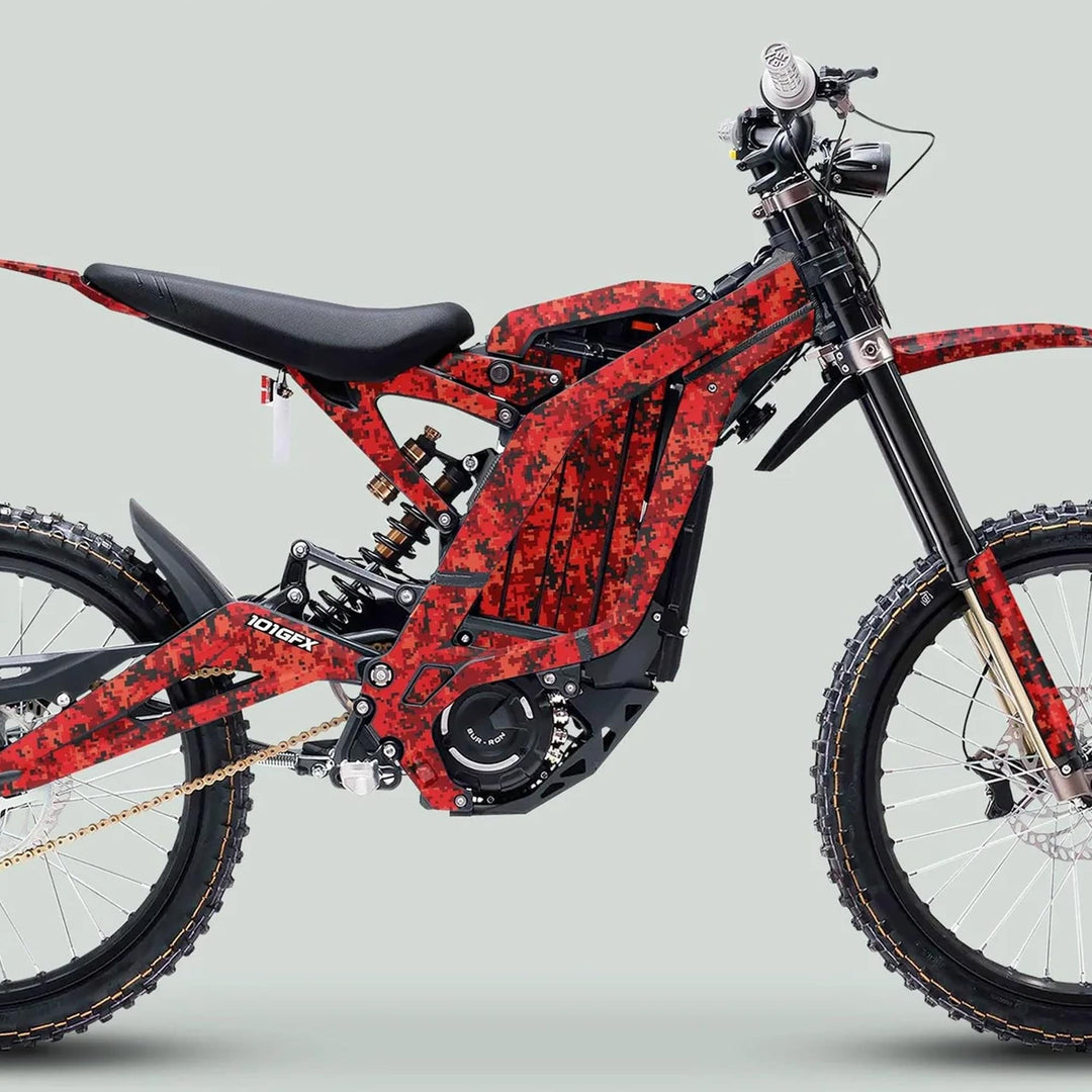 Side-profile of an off-road electric dirt-bike featuring the Surron Light Bee X Graphics Kit SQUARE TEK Red with red digital-camo wrap and durable, glossy laminated finish.