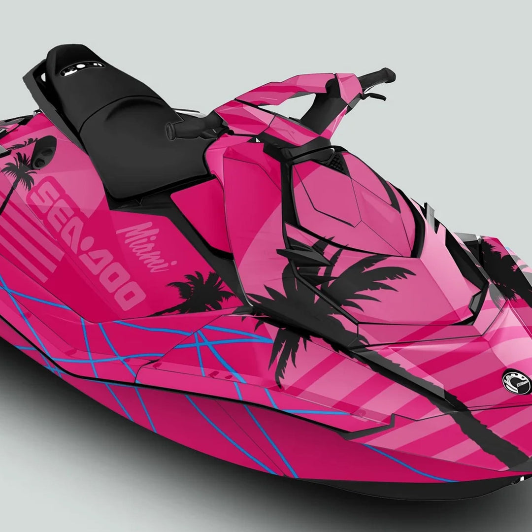 Sea Doo Spark Graphics Kit MIAMI MAGENTA PINK on a jet-ski, featuring palm-tree silhouettes and blue pin-stripes, enhancing style with vibrant, durable vinyl.