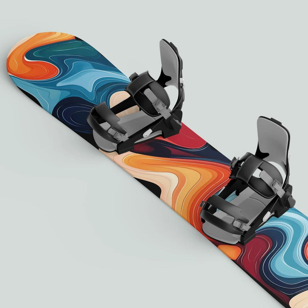 Snowboard with Snowboard Wrap FLOW sticker decals featuring abstract swirl graphics and mounted black bindings, offering style and protection for winter sports enthusiasts.
