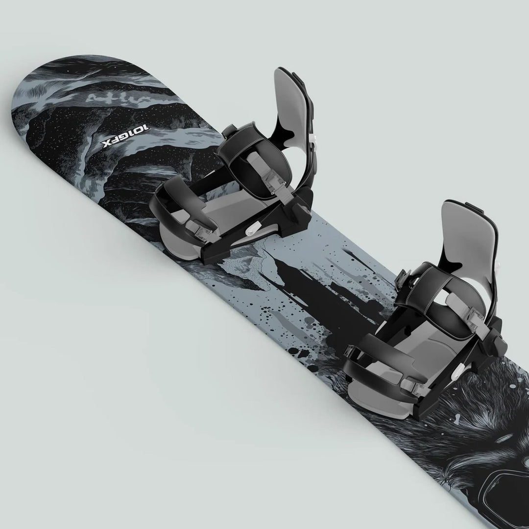 Snowboard Wrap SNOWER GREY on a board with black and gray bindings, featuring an abstract black-and-white graphic for stylish, durable snowboard protection.