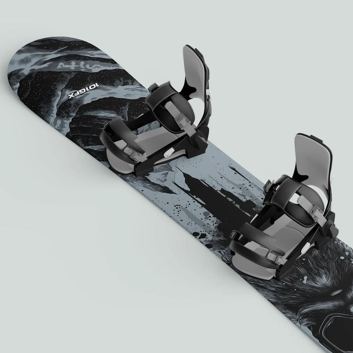 Snowboard Wrap SNOWER GREY on a board with black and gray bindings, featuring an abstract black-and-white graphic for stylish, durable snowboard protection.