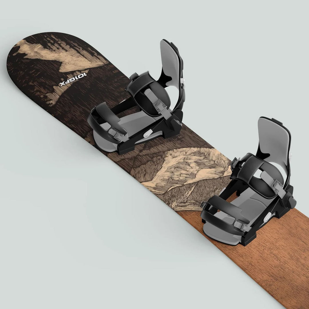 Snowboard with Snowboard Wrap WOODCUT MOONLIGHT decals, featuring wood-grain graphics and black-gray bindings, enhancing design and protection against scratches.