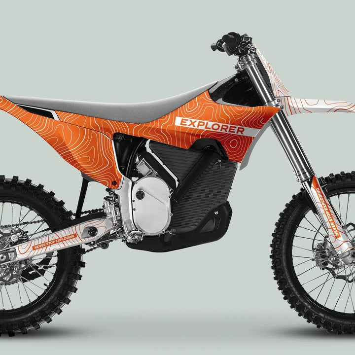 Side-view of the Stark Varg Graphics Kit EXPLORER ORANGE WHITE Decals, featuring contour-map graphics and NEVER STOP EXPLORING text on an electric motocross bike.