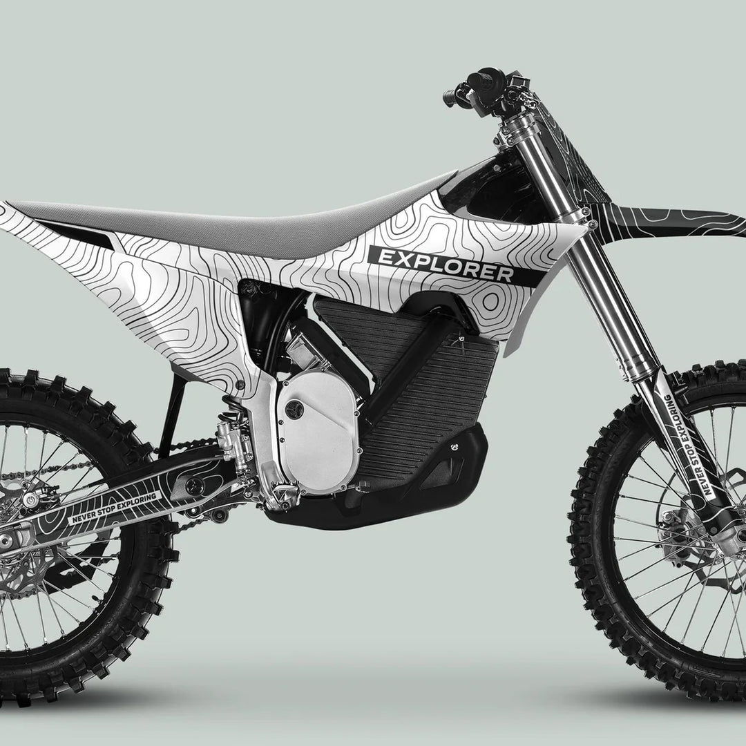 Stark Varg Graphics Kit EXPLORER WHITE GREY Decals on an electric adventure bike, showcasing white-and-black topographic graphics with EXPLORER on the side.