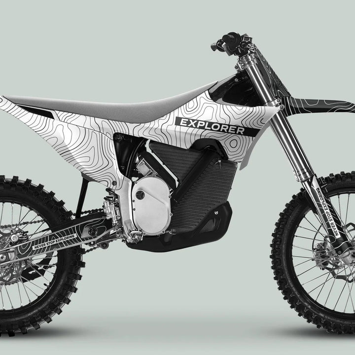 Stark Varg Graphics Kit EXPLORER WHITE GREY Decals on an electric adventure bike, showcasing white-and-black topographic graphics with EXPLORER on the side.